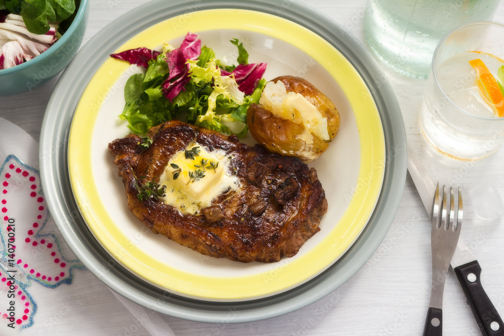 Summer steak with baked potato and salad 