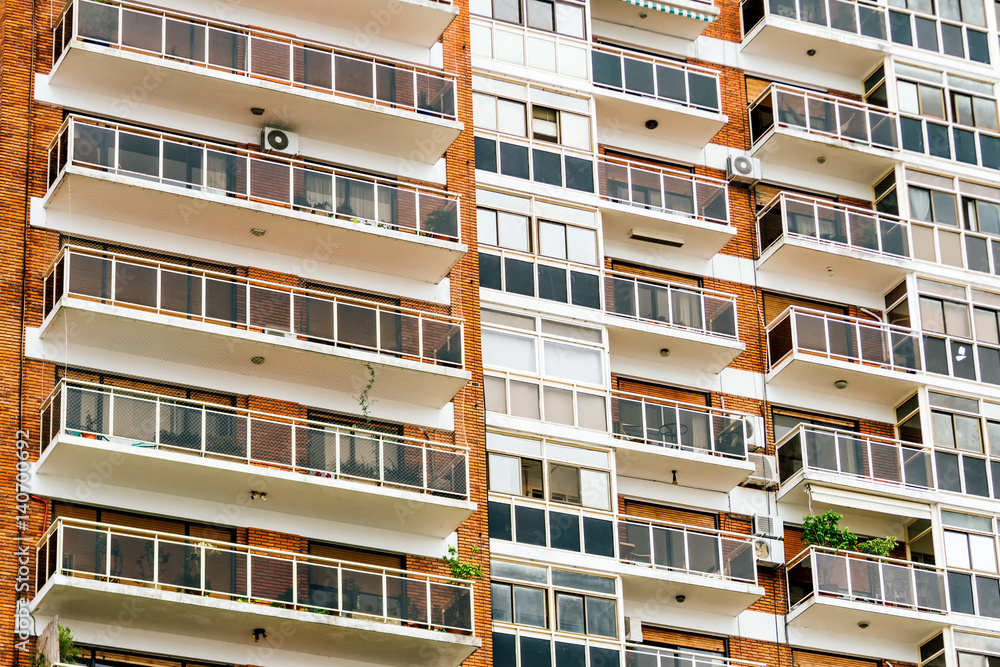 Apartment building with balconies and brick walls Apartment building with balconies and brick walls