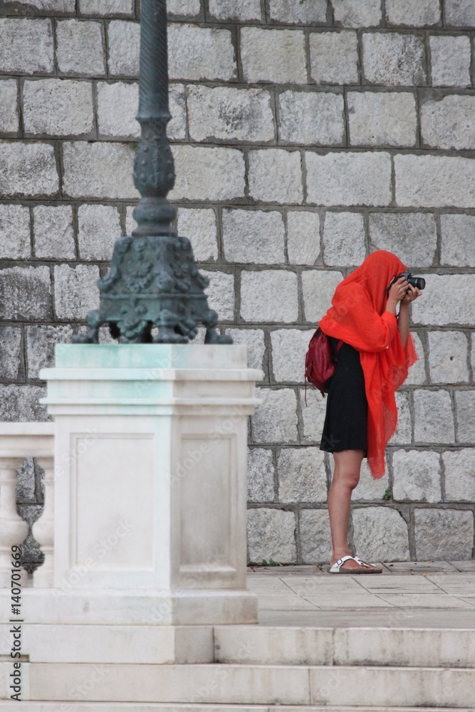A woman is taking pictures in the rain. A woman is taking pictures in the rain.