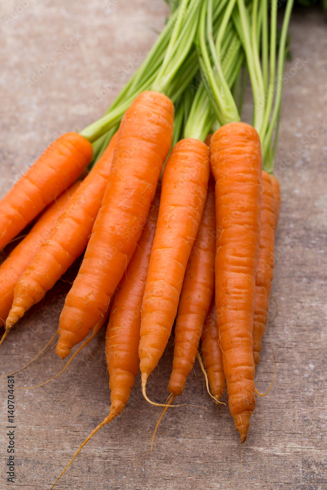 Fresh and sweet carrot on a grey wooden table. Fresh and sweet carrot on a grey wooden table.