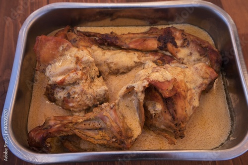Roasted or baked rabbit meat in dijon mustard sauce in the shallow stainless steel pan. Typical exapmle of the French rustical cuisine, all ingredients are fresh and without any additives.