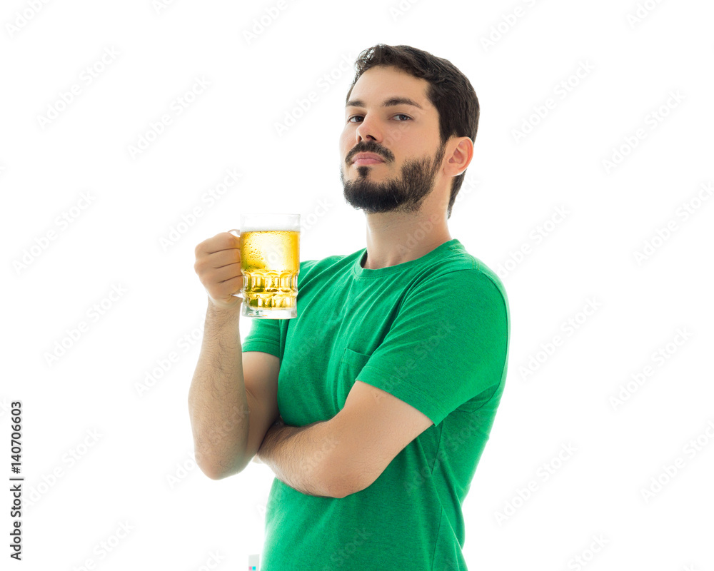 Man is holding a mug of bier.