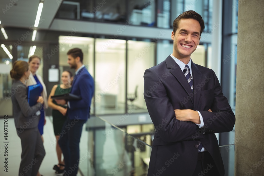 Portrait of businessman standing with arms crossed in corridor Portrait of businessman standing with arms crossed in corridor