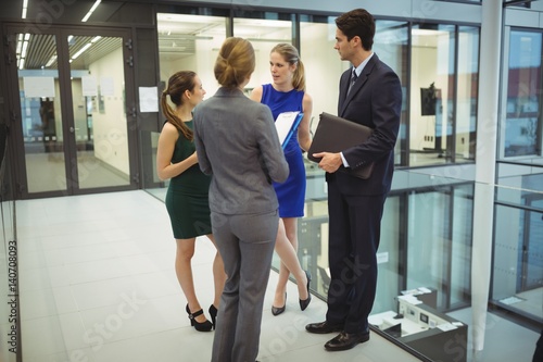 Businesspeople having a discussion in the corridor