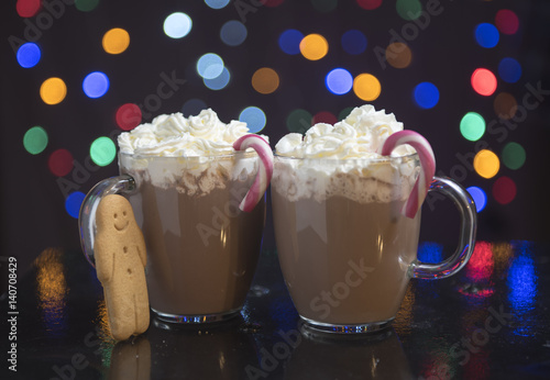 Hot chocolate with cream, candy canes and gingerbread men