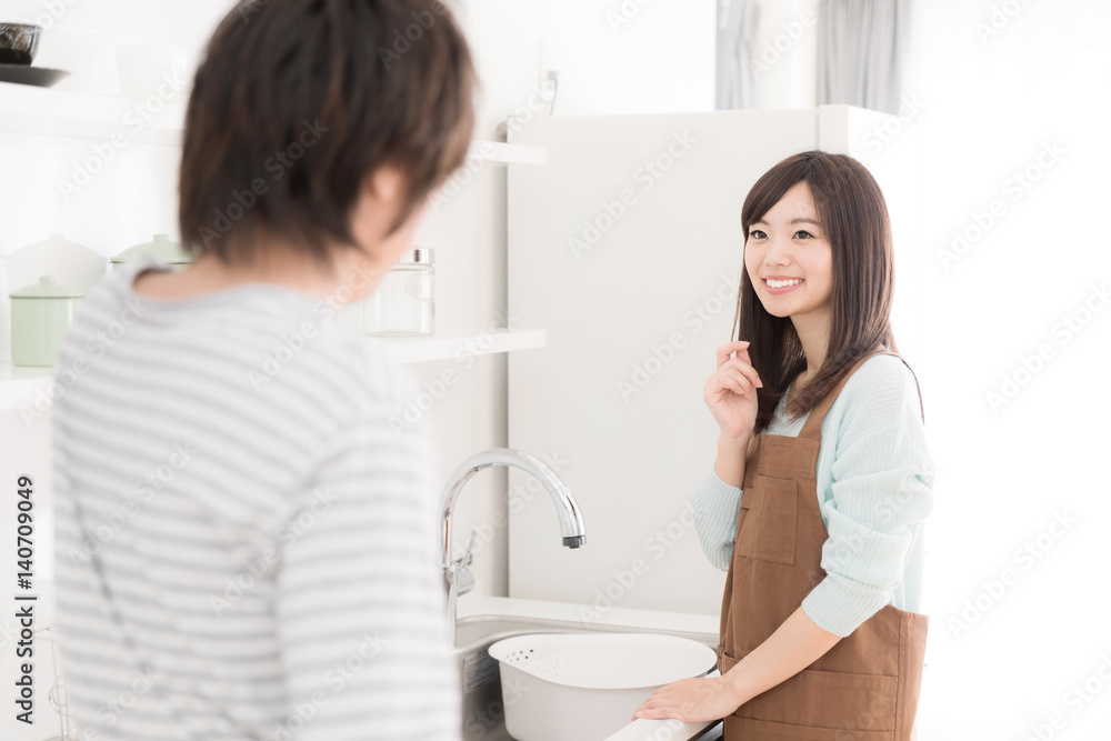 young asian couple in modern kitchen young asian couple in modern kitchen