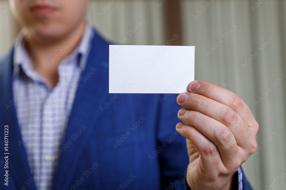 Businessman holding visit card. Man showing blank business card. Person in blue suit. Mock up design. Businessman holding visit card. Man showing blank business card. Person in blue suit. Mock up design.
