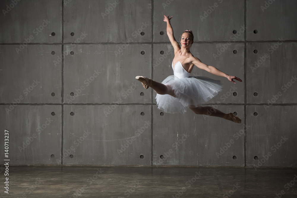 Ballerina in white dress doing Grand pas de sha (big cat's jump) (focus is on the dress) Ballerina in white dress doing Grand pas de sha (big cat's jump) (focus is on the dress)