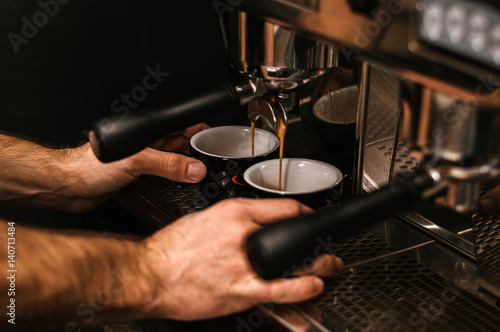 Barista hands while making a cup of coffee