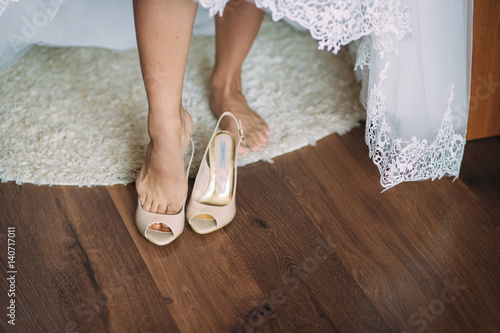 bride wears shoes photo