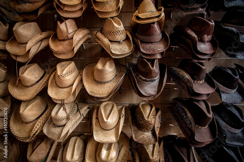 Rack of straw cowboy hats photo
