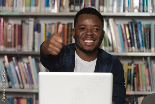 African Man In A Library Showing Thumbs Up