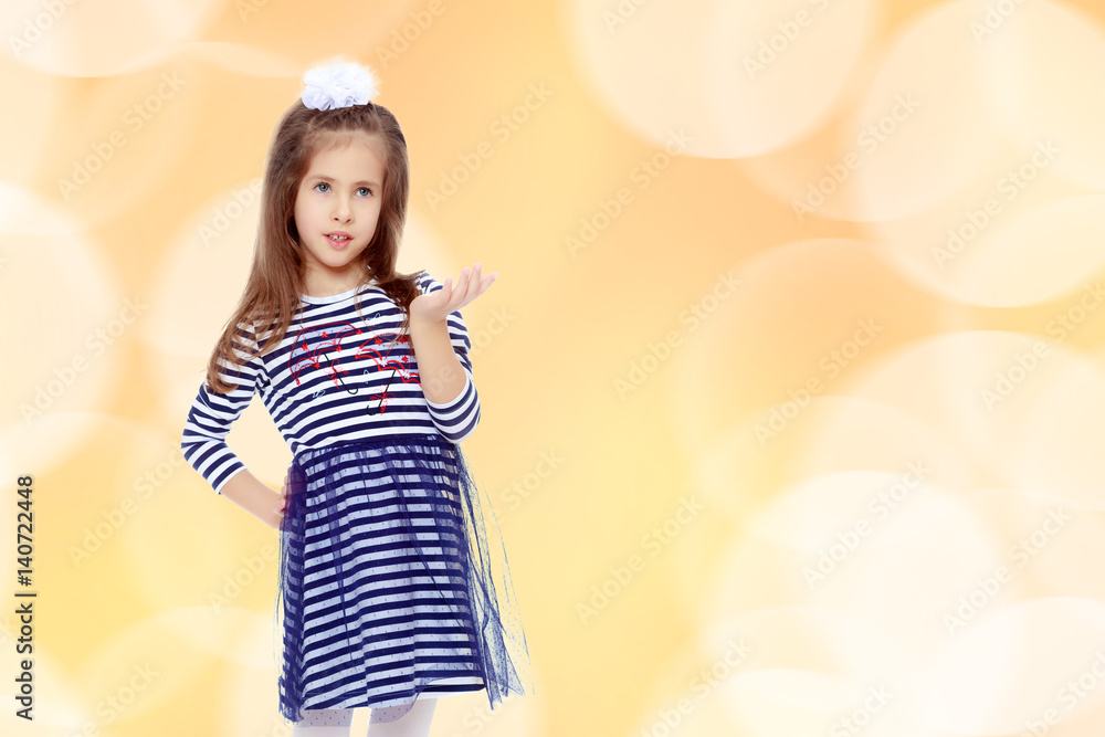 Cute little girl posing in front of the camera. Cute little girl posing in front of the camera.