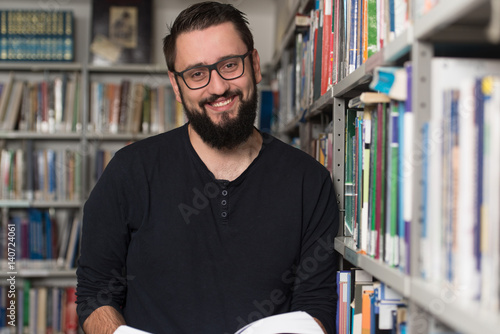 Male College Student In A Library