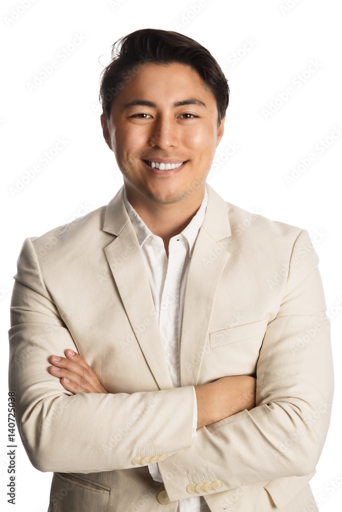 Handsome relaxed businessman in a bright beige suit, standing against a white background smiling. Handsome relaxed businessman in a bright beige suit, standing against a white background smiling.