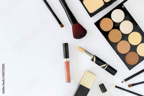 makeup cosmetics on white table background, over light, top view
