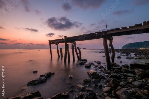 Sunset at pier on rock beach in Koh Chang, Thailand © Pixelatelier.at
