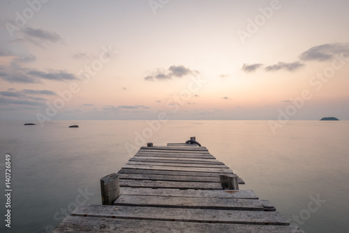 Fototapeta Naklejka Na Ścianę i Meble -  Sunset at pier on rock beach in Koh Chang, Thailand