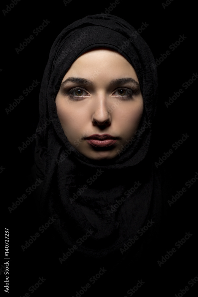 Φωτογραφία Female wearing a black hijab as a conservative fashion choice to represent feminist freedom of expression and political statement
