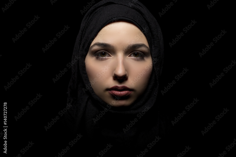 Φωτογραφία Female wearing a black hijab as a conservative fashion choice to represent feminist freedom of expression and political statement