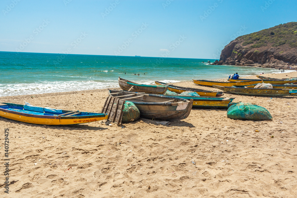 Wide view of group of fishing boats parked in seashore with sea background, Visakhapatnam, Andhra Pradesh, March 05 2017