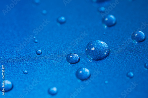 Closeup water drops on blue background