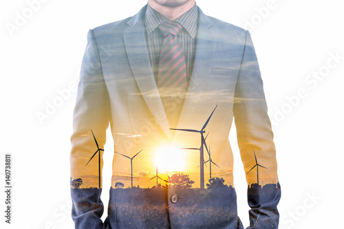 Double exposure of businessman with silhouette of wind turebine  photo