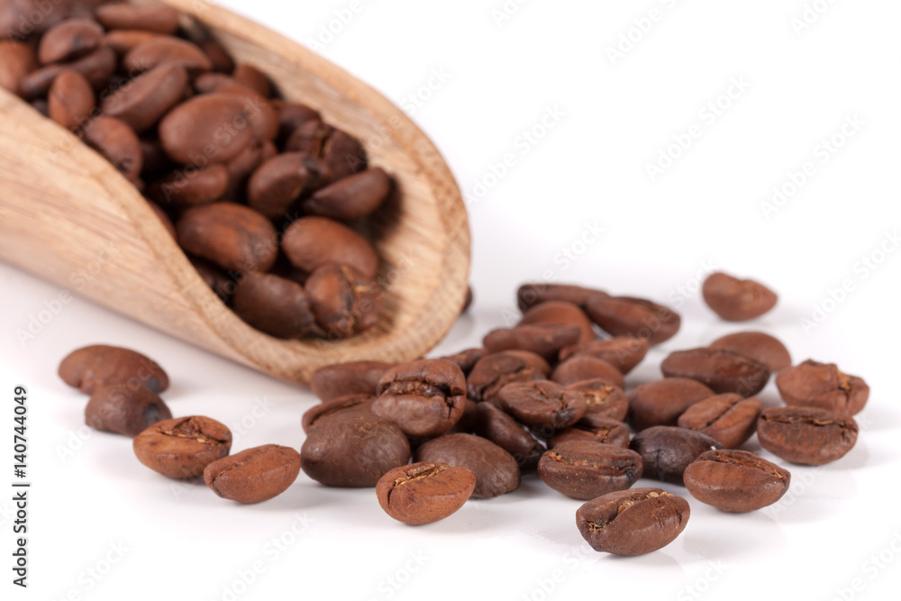 coffee beans in a wooden scoop isolated on white background coffee beans in a wooden scoop isolated on white background