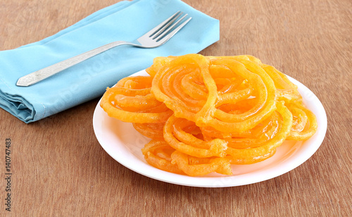 Jalebis, Indian sweet dish, fresh and homemade, in a plate. photo