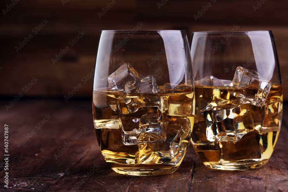 glass of whiskey with ice on a wooden glass of whiskey with ice on a wooden