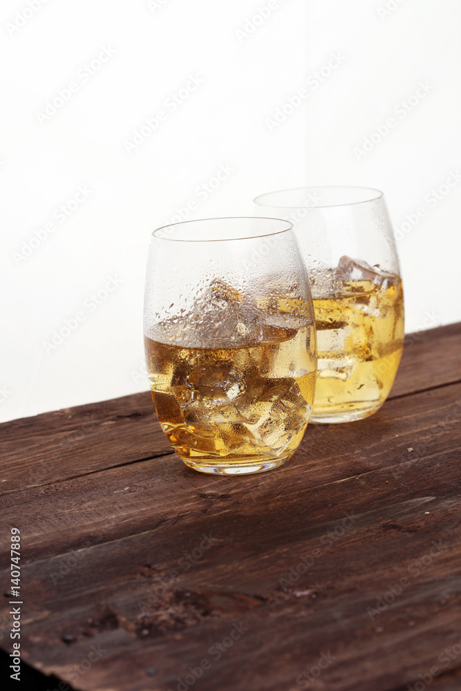 glass of whiskey with ice on a wooden glass of whiskey with ice on a wooden