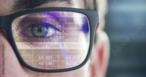 Wallpaper Mural Close up of young businessman with blue eyes wearing the glasses looking on the waveform lines and data Torontodigital.ca