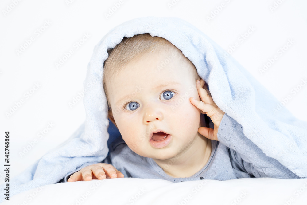 beautiful baby boy lying in bed on white background beautiful baby boy lying in bed on white background