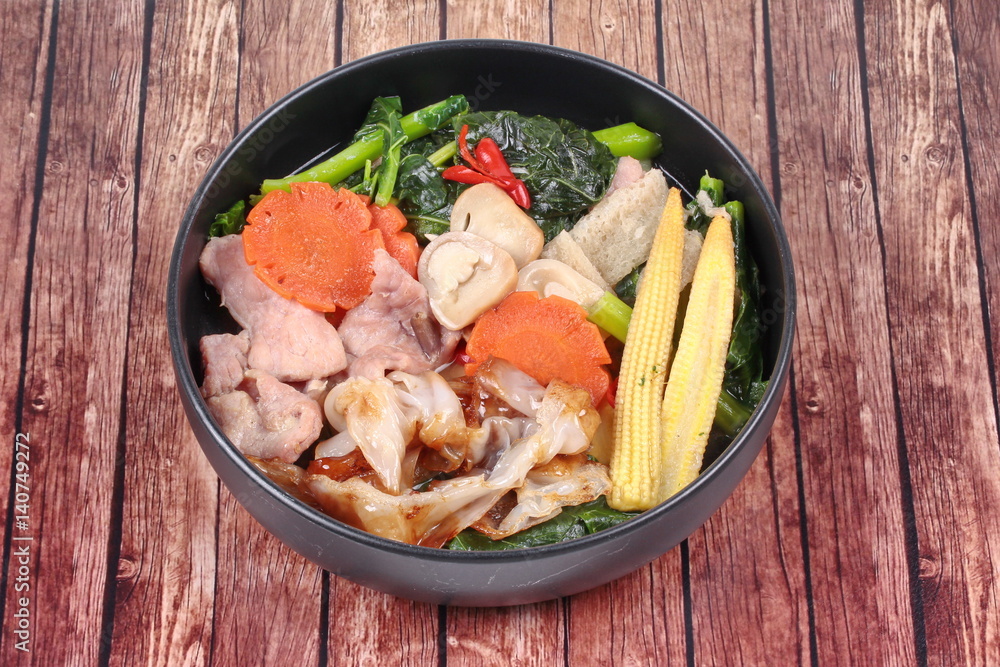 Fried big noodle with Chinese kale ,pork,vegetable in soup. Fried big noodle with Chinese kale ,pork,vegetable in soup.