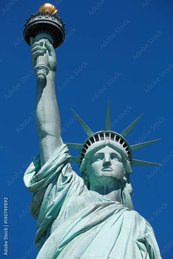 Fototapeta premium Statue of Liberty in a sunny day, blue sky in New York