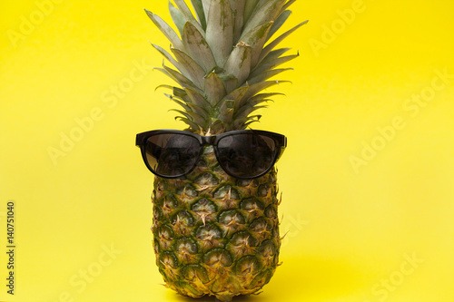 pineapple in sunglasses on yellow background
