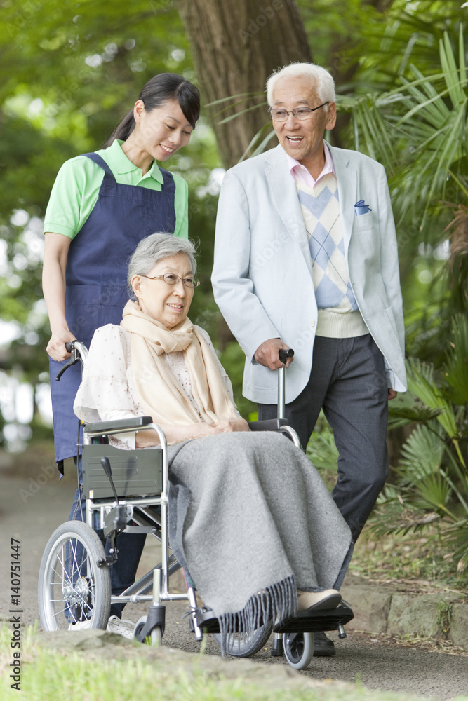 Healthcare worker pushing senior woman in wheelchair, Tokyo Prefecture, Honshu, Japan Healthcare worker pushing senior woman in wheelchair, Tokyo Prefecture, Honshu, Japan