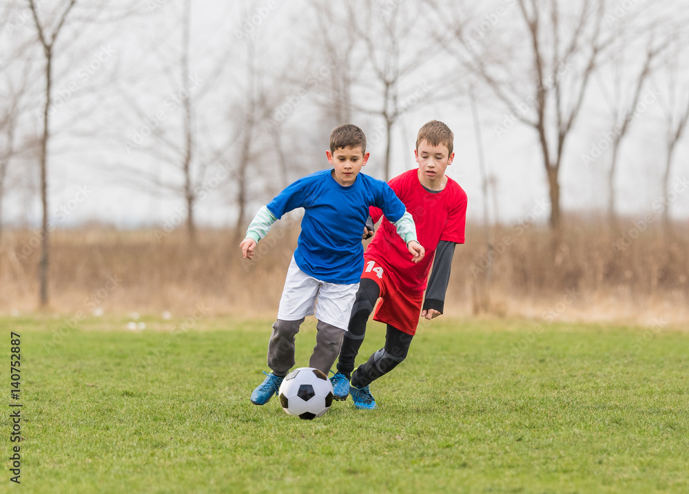 Kids soccer football - children players match on soccer field Kids soccer football - children players match on soccer field
