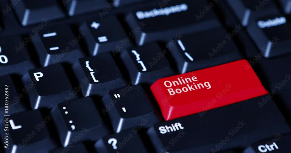 Male finger presses a red button with text of Online Booking on the computer keyboard Male finger presses a red button with text of Online Booking on the computer keyboard