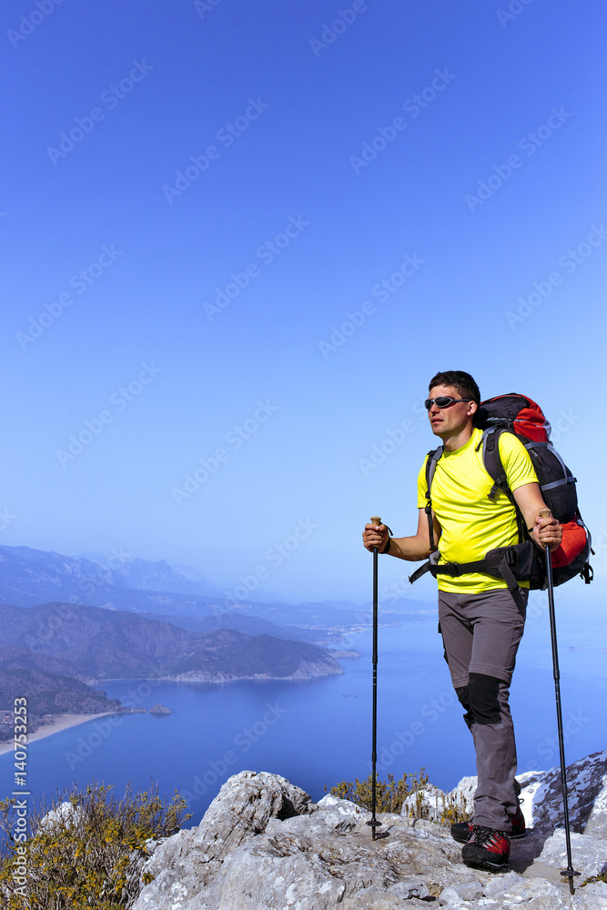 A man with a backpack hiking in the mountains.