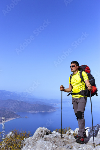 A man with a backpack hiking in the mountains.