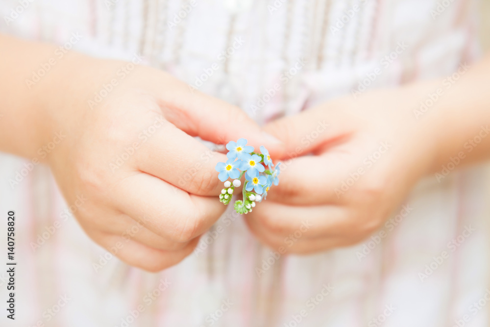 Spring - Forget me not flowers in little child's hands Spring - Forget me not flowers in little child's hands