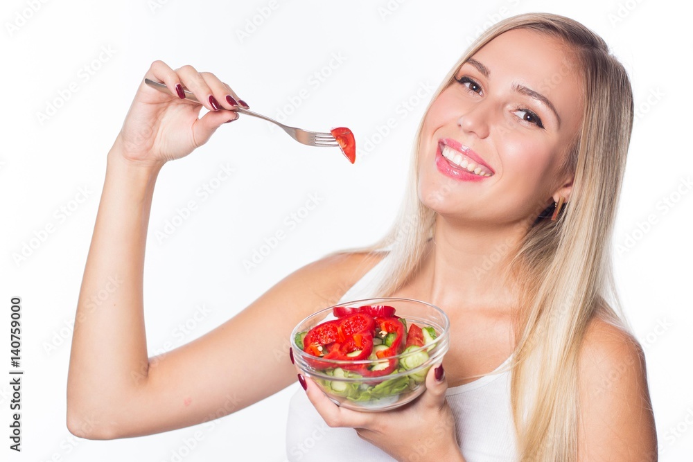 Young beautiful woman eats vegetable salad. Healthy eating. To be in shape. Young beautiful woman eats vegetable salad. Healthy eating. To be in shape.