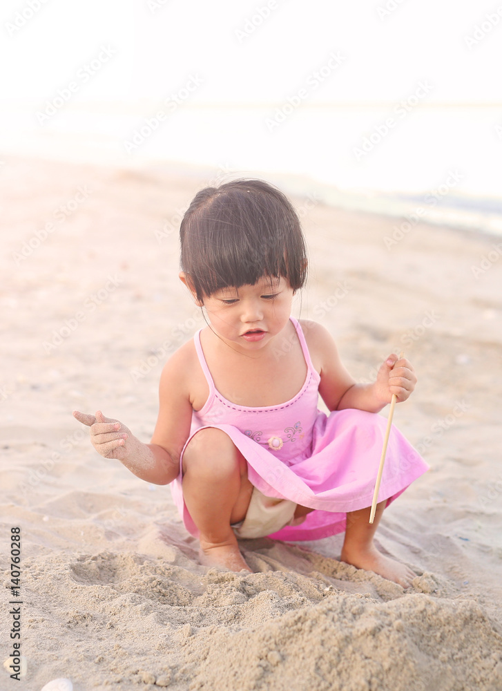 Portrait Kid girl playing sand at the beach Portrait Kid girl playing sand at the beach