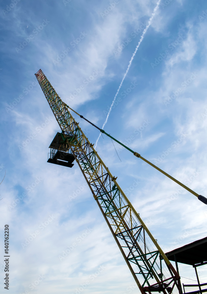 Bungee jumping cabin and cran.People in flight from a height.