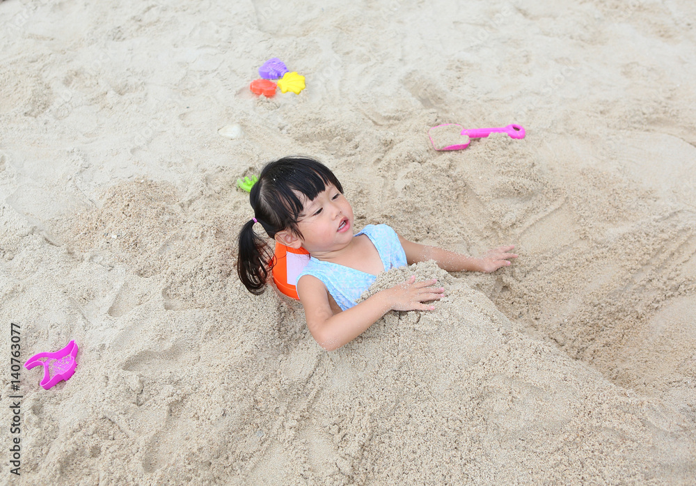 Cute child girl playing sand at the beach Cute child girl playing sand at the beach