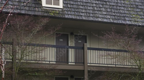 Zoom-in on the doors of two guest rooms on the third floor of an inn in Grants Pass, Oregon