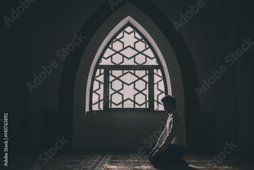 Muslim praying in a building with perfect background