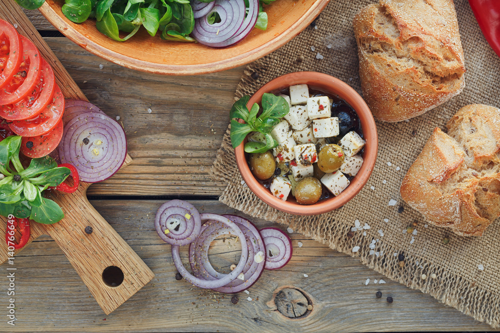 Fototapeta premium Ingredients for vegetables salad on a wooden background.