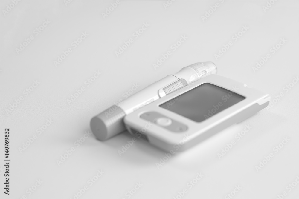 Medicine, diabetes, glycemia, health care and people concept - Glucose meter and lancet device for the diagnosis of glucose Medicine, diabetes, glycemia, health care and people concept - Glucose meter and lancet device for the diagnosis of glucose